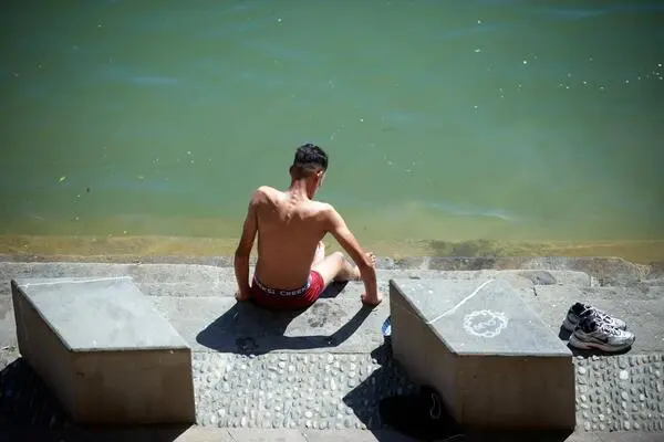 A man tries to cool off in Toulouse, France. The heat wave that is currently gripping Europe would have been 3.5 degrees Celsius cooler 50 years ago. 