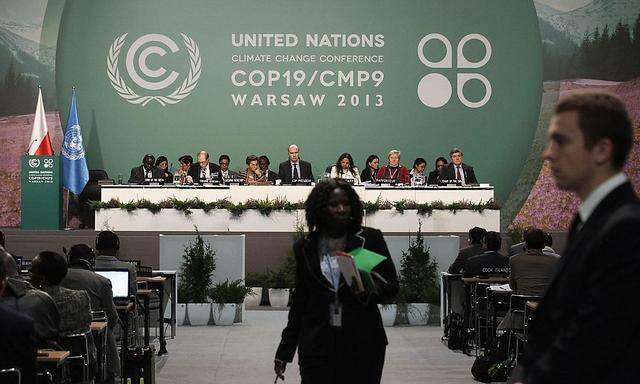 Delegates attend the closing session of COP19 in Warsaw