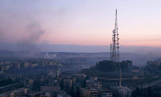Smoke rises as seen from a government controlled area of Aleppo