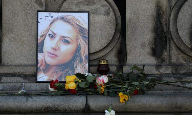 Flowers and candles are placed in memory of Bulgarian TV journalist Viktoria Marinova in Ruse
