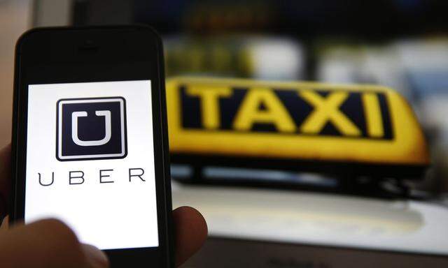 An illustration picture shows the logo of car-sharing service app Uber on a smartphone next to the picture of an official German taxi sign