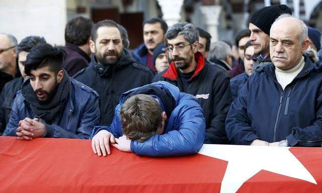 Relatives react at the funeral of Arik, a victim of an attack by a gunman at Reina nightclub, in Istanbul
