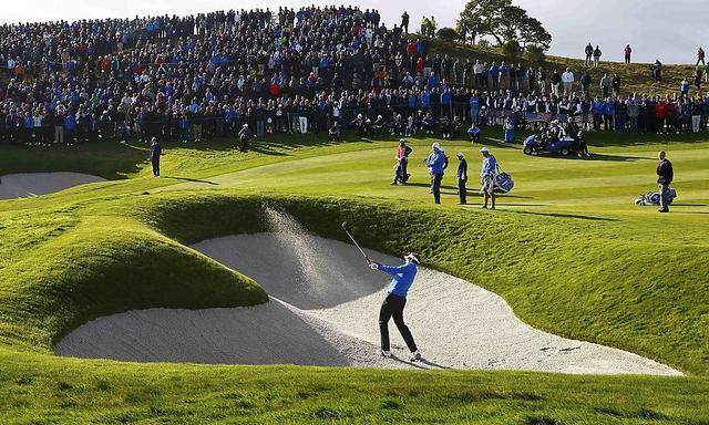 European Ryder Cup player Ian Poulter hits out of a bunker during his fourballs 40th Ryder Cup match at Gleneagles 