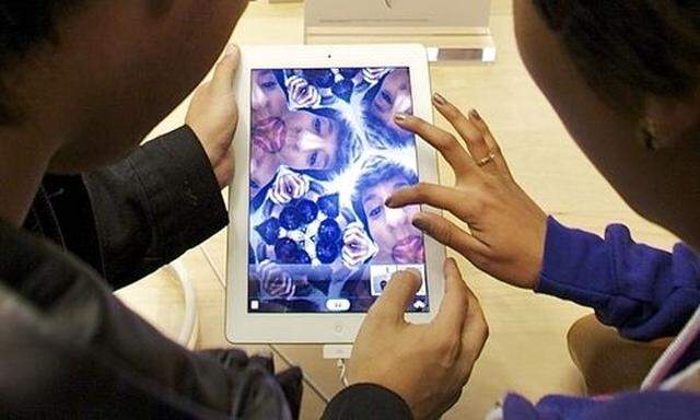 Shoppers try the front camera of the new iPad 2 at The Grove Apple store in Los Angeles Friday, March