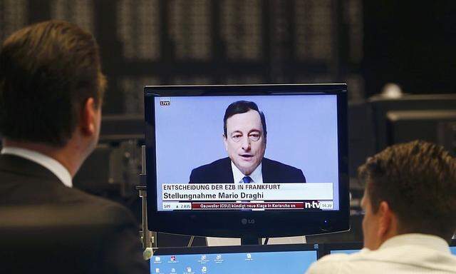 Traders watch ECB news conference during a trading session at Frankfurt stock exchange