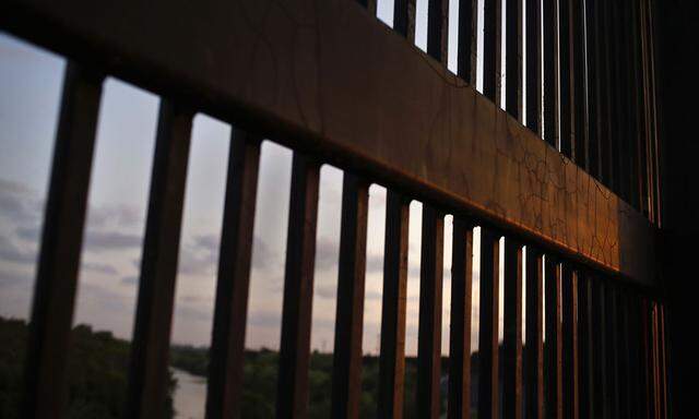 The border fence stands at the United States-Mexico border along the Rio Grande river in Brownsville, Texas