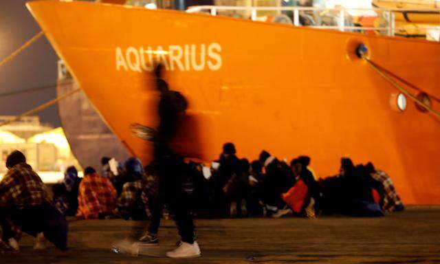 FILE PHOTO: Migrants disembark from the MV Aquarius after its arrivalgen in Sicily in January