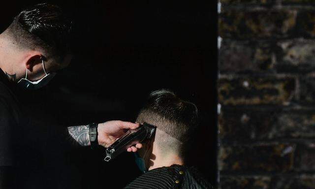 Daily Life In Dublin A hairdresser serves a customer at a barbershop in Dublin s Temple Bar. On Thursday, 13 May 2021, i