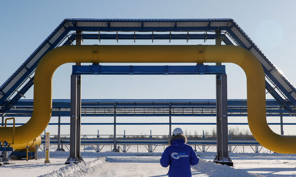 FILE PHOTO: An employee walks past a part of Gazprom's Power Of Siberia gas pipeline at the Atamanskaya compressor station outside the far eastern town of Svobodny