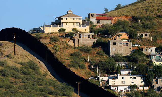 File photo of buildings in Nogales, Mexico separated by a border fence from Nogales, Arizona