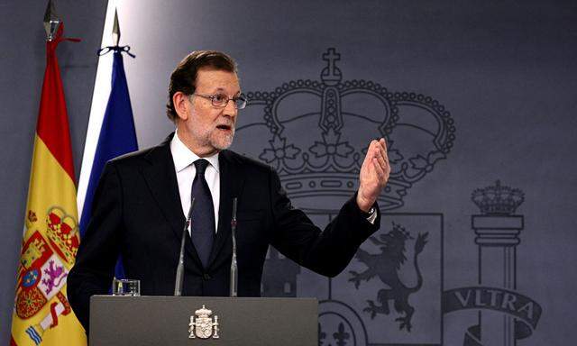 Spain´s acting PM Rajoy gestures during a news conference at Moncloa Palace in Madrid