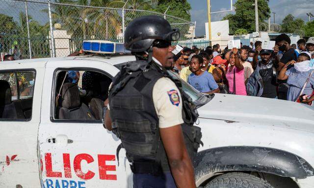 Ein Polizist vor der US-Botschaft in Haiti, wo sich hunderte Menschen versammelten und sich um ein Visum bemühten.
