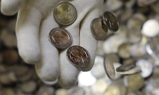 Two Euro coins are seen in the Austrian Mint headquarters in Vienna