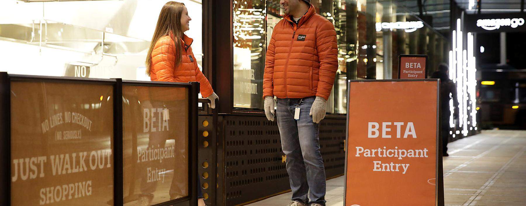 A customer walks out of the Amazon Go store, without needing to pay at a cash register due to cameras, sensors and other technology that track goods that shoppers remove from shelves and bill them automatically after they leave, in Seattle