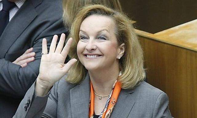 Austrian Finance Minister Maria Fekter waves as she arrives for her budget speech in the Parliament i