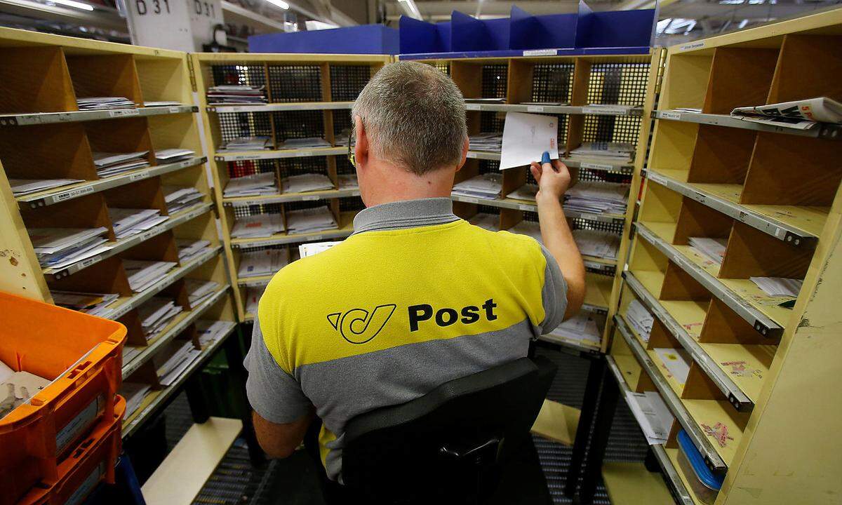A worker sorts mail at Austrian Post logistics centre in Vienna