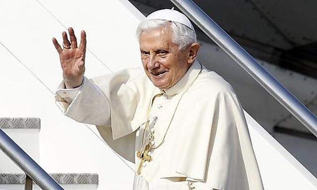 Pope Benedict XVI waves as he boards his plane to leave for his pastoral visit to Mexico and Cuba, at