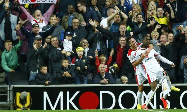  Benik Afobe of Milton Keynes Dons celebrates his goal against Manchester United with George Baldock during their League Cup game at stadiummk in Milton Keynes