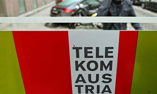 A man talks on his mobile phone outside a Telekom Austria phone booth in Vienna