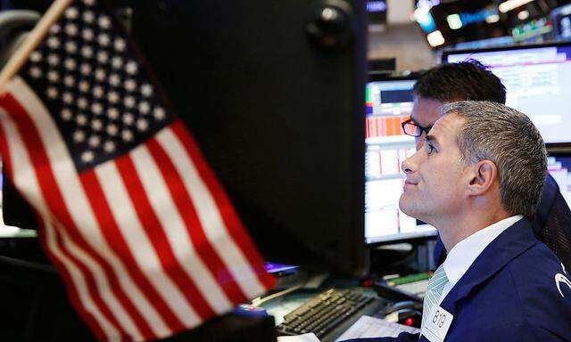 A trader works on the floor of the NYSE