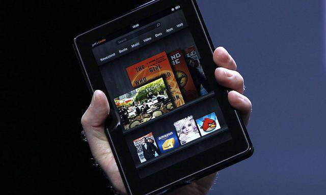 Jeff Bezos holds up the new Kindle Fire at a news conference during the launch of Amazon´s new tablets in New York