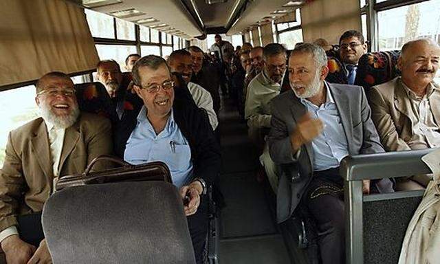 Senior leaders of Palestinian factions in Gaza wait in a bus at the Rafah border crossing in the sout