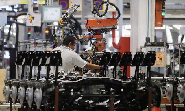 An employee works on the production line of the Volkswagen Tiguan cars at the company's assembly plant in Puebla,