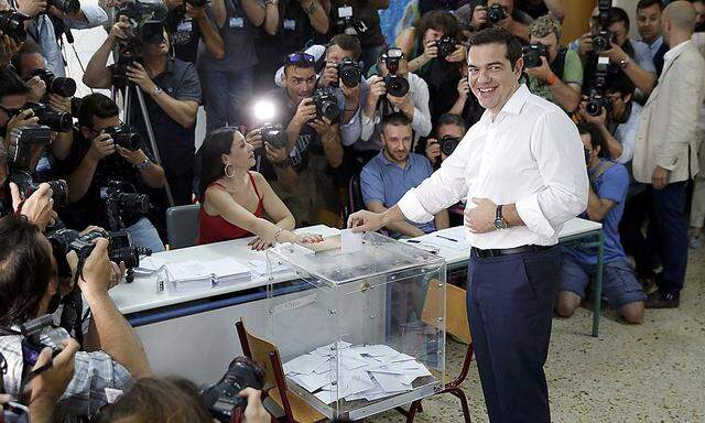 Greek Prime Minister Alexis Tsipras votes in national referendum at a polling station in Athens