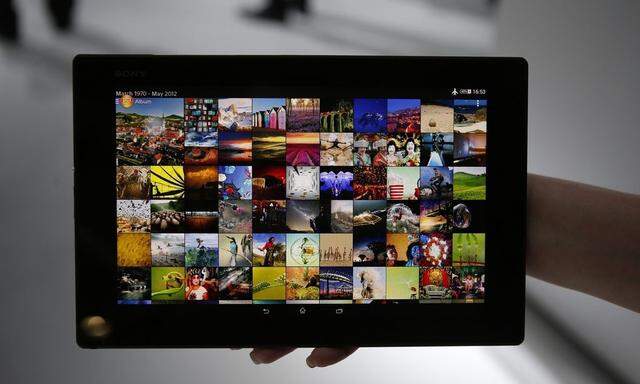 A woman holds a Sony Xperia Z2 tablet at the Mobile World Congress in Barcelona