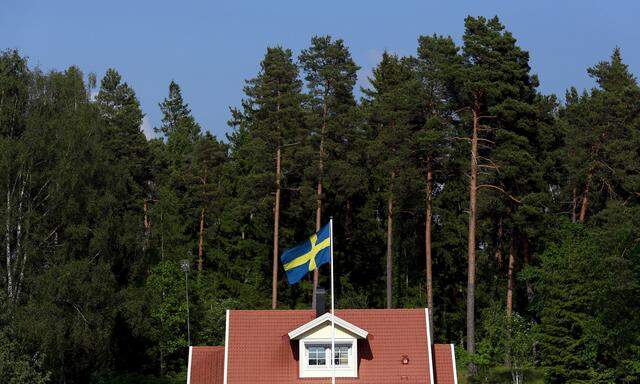 File photo of Swedish national flag flying in front of a house near the town of Sodertalje