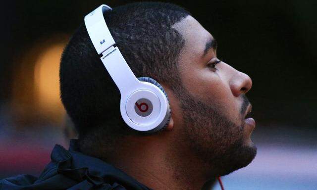 A man listens to Beats brand headphones on a street in New York