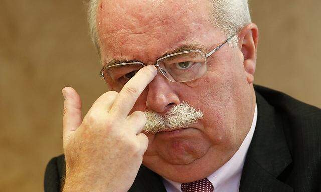 Christophe de Margerie, CEO of French oil and gas company Total SA, adjusts his glasses as he speaks during interview with Reuters in Paris