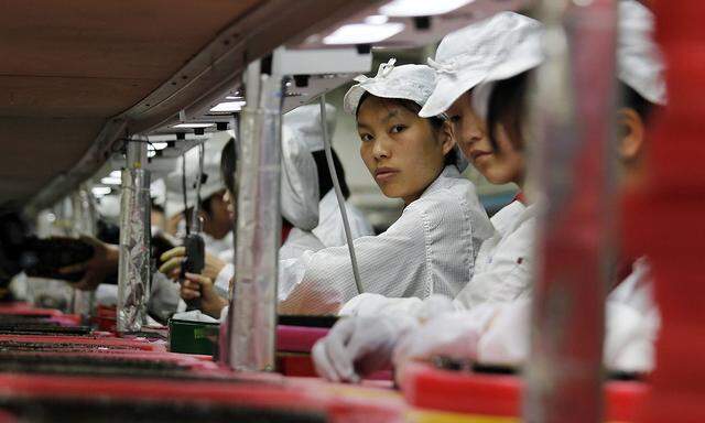 File photo shows workers inside a Foxconn factory in the township of Longhua in the southern Guangdong province