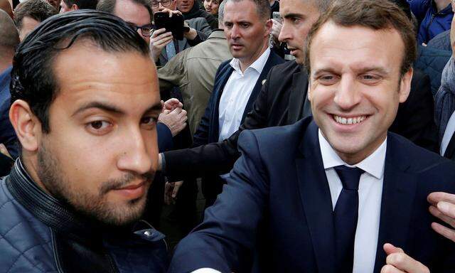 FILE PHOTO: Emmanuel Macron, head of the political movement En Marche !, or Onwards !, and candidate for the 2017 presidential election, flanked by Alexandre Benalla, head of security, attends a campaign visit in Rodez