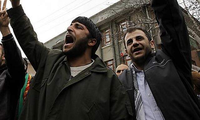 Supporters of the pro-Kurdish Democratic Society Party (DTP) shout slogans in front of the DTP headqu