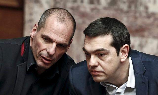 File photo of Greek PM Tsipras and Finance Minister Varoufakis talking during the first round of a presidential vote at the Greek parliament in Athens