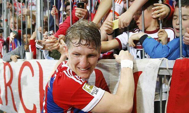 Bayern Munich's Schweinsteiger celebrates with fans after scoring a goal against Hertha Berlin during Bundesliga first division soccer match in Munich