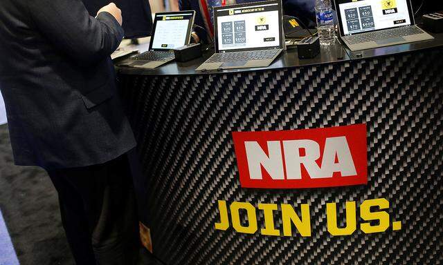 People sign up at the booth for the National Rifle Association (NRA) at the Conservative Political Action Conference (CPAC) at National Harbor, Maryland