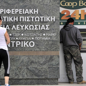 People gather at an automatic teller machine in Nicosia