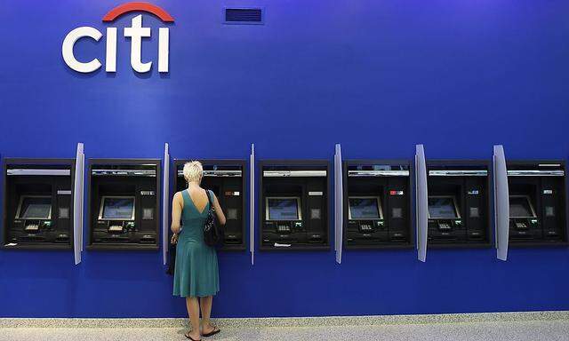 A woman uses an ATM inside a Citi bank branch in New York