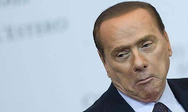 Italy Prime Minister Silvio Berlusconi makes a face as he attends a meeting in Rome