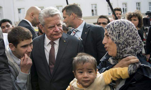 German President Gauck visits an asylum seekers accommodation facility in Berlin