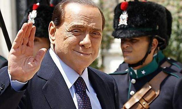 Italian Prime Minister Berlusconi waves as he arrives for a meeting with Maltas Prime Minister Gonzis Prime Minister Gonzi