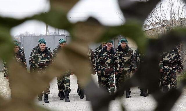 Ukrainian servicemen, recently mobilized to join border troops, walk in formation at tent camp located near border of Ukraine with Moldova's self-proclaimed separatist Transdniestria region, in Odessa region