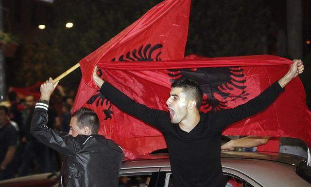 Albanian soccer fans react with national flags in Tirana, after the Euro 2016 qualifier between Serbia and Albania was abandoned