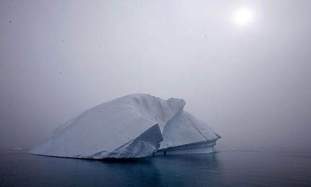 An iceberg melts in Kulusuk Bay, eastern Greenland Tuesday July 17, 2007. The melting of the Greenlan