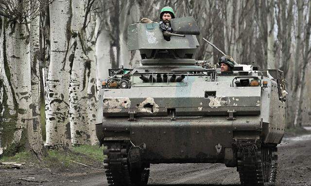 Ukrainische Soldaten auf einem niederländischen gepanzerten Mannschaftstransportwagen  auf einer Straße in der Nähe von Bachmut am 6. April.