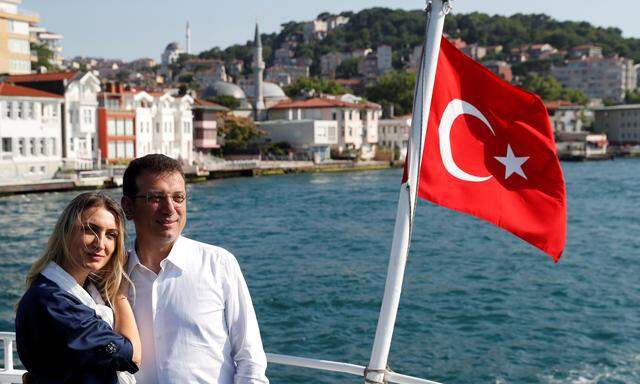 Ekrem Imamoglu, mayoral candidate of the main opposition CHP, poses in a boat following an election rally in Istanbul