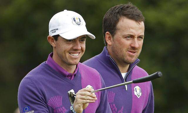European Ryder Cup players Rory McIlroy and Graeme McDowell walk off the tee during practice ahead of the 2014 Ryder Cup at Gleneagles