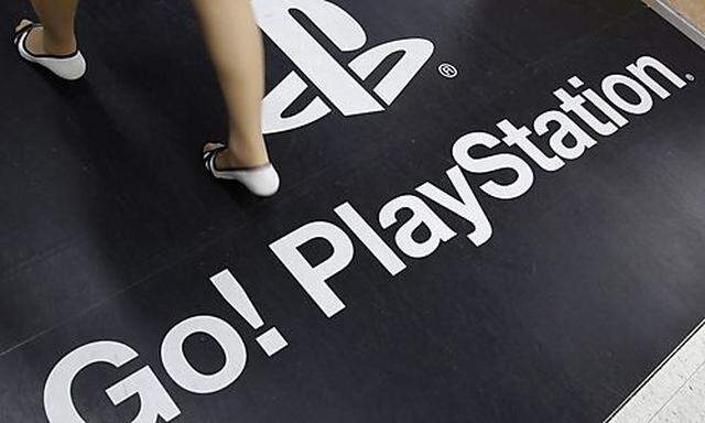 A woman walks on a floor advertisement for Sony Corps PlayStation 3 game console at an electronic sts PlayStation 3 game console at an electronic st